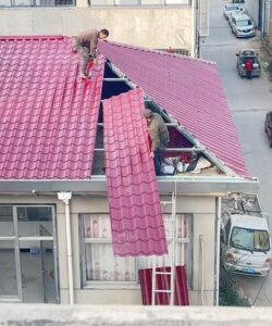 Installation of colored coated corrugated roof panels, renovation of old houses Installation of colored coated corrugated roof panels, renovation of old houses