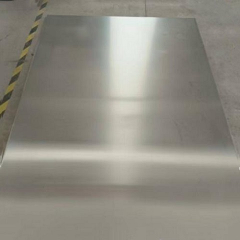 Magnet held firmly to a 430 stainless steel sheet demonstrating strong magnetic pull
